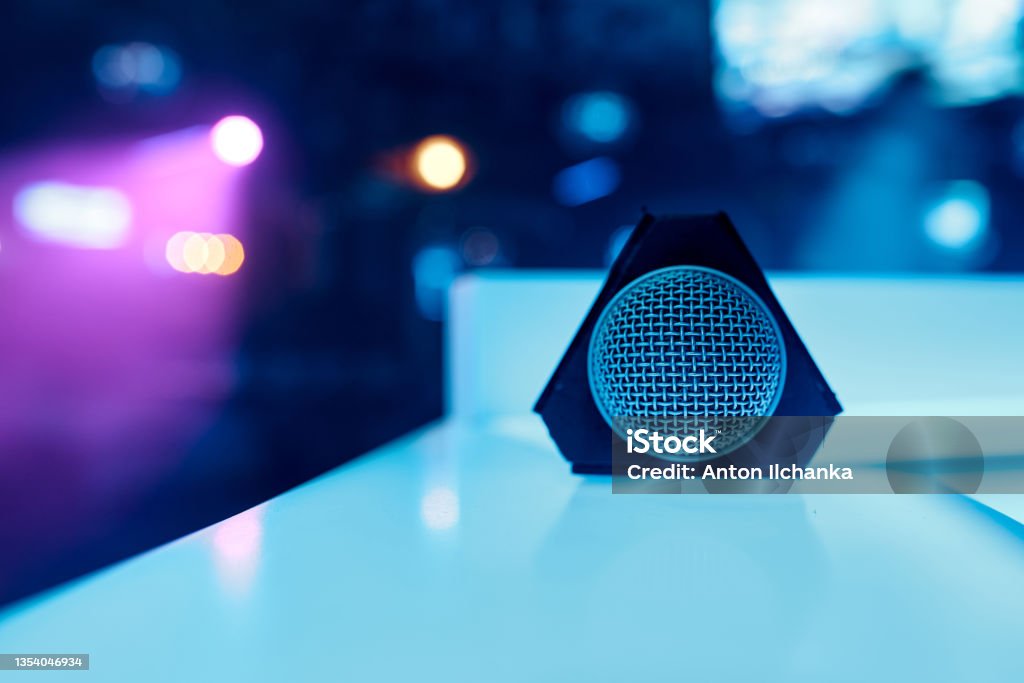 Triangular Mic Microphone With Triangular Nozzle Lies On A White Table Grid On The ...