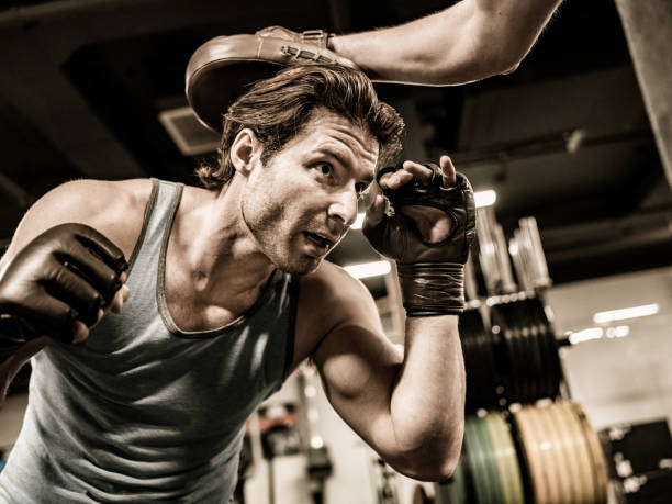 istock Two Young Men boxing in the Gym 1354048246
