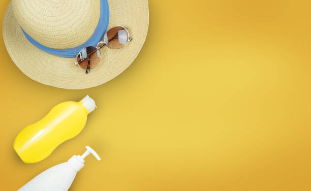 istock Hat, glasses, and body cream on a yellow background. 1354048443