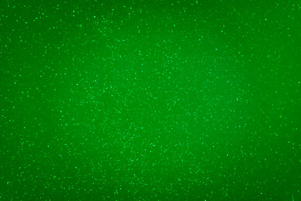 Bright green background. Christmas, New Year  background. Background with glitter. Copy space.