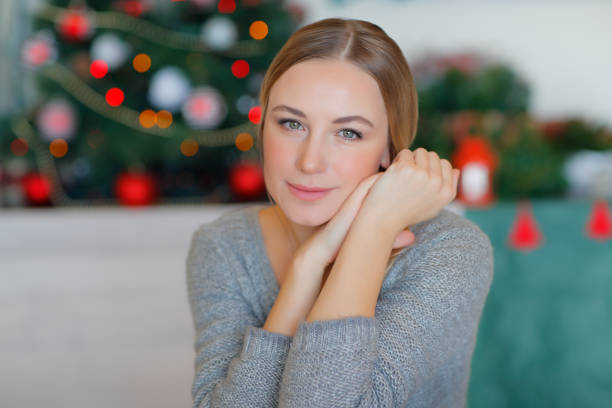 istock Beautiful Woman near Christmas Tree 1354053461