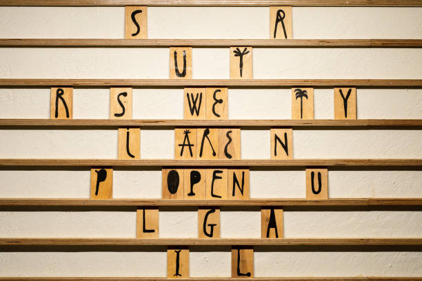 istock We are open text message written with wooden cubes on the board. Unique font. White background 1354053785