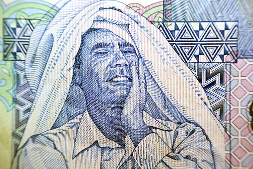 Portrait of Muammar Al Gaddafi (1942-2011) The ruler of Libya from 1969 to 2011, The obverse side of the Libyan one dinar banknote Libyan money, Close up Macro, selective focus