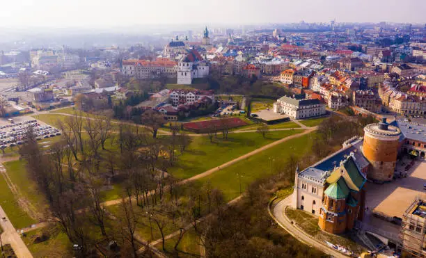 Scenic spring cityscape of historical part of Lublin with Castle tower and Holy Trinity Chapel in foreground, Poland