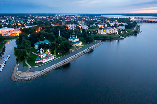 Aerial view of Uglich with Kremlin cathedrals on banks of Volga River at twilight, Russia