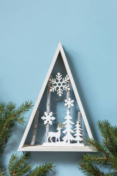 istock Christmas mockup with fir tree Christmas decor on blue background. Preparation for celebration xmas. Copy space. 1354057098