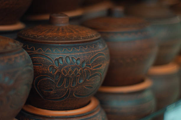 A row of handmade clay pots with a defocused background. Ceramic baking dish in the oven