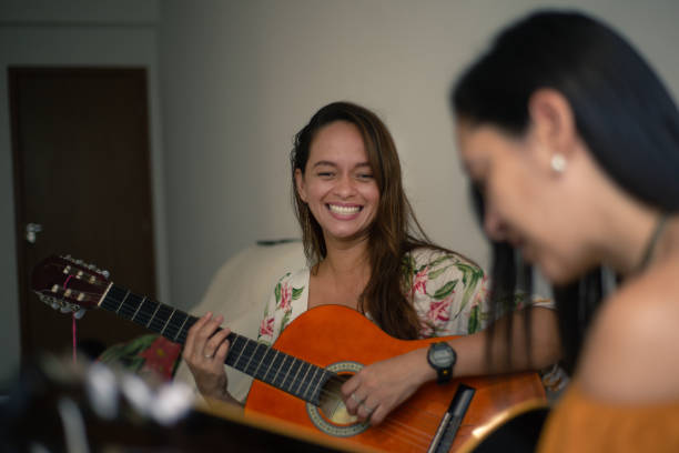 istock Women singing and playing the guitar. 1354058376