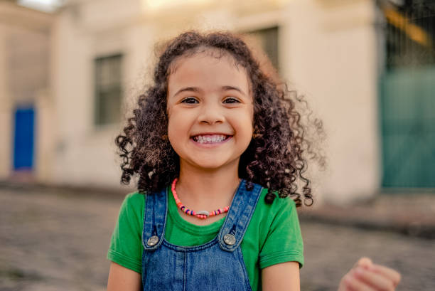 Small girl smiling on the street. Small girl smiling on the street. looking at the camera brazilian ethnicity photos stock pictures, royalty-free photos & images