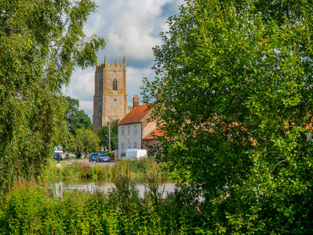 istock Great Massingham church and pond 1354060666