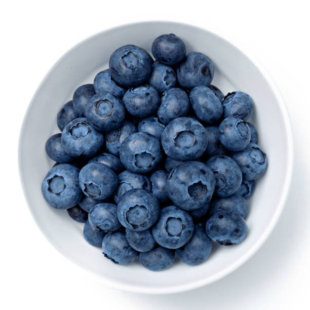 istock Fresh blueberries in bowl isolated on white. Top view. 1354061977