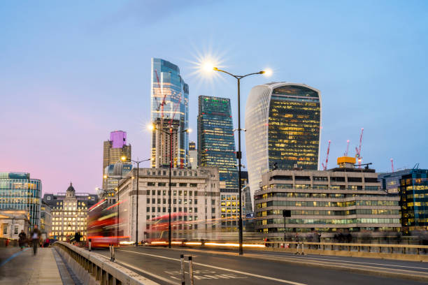 City of London financial district skyscrapers at dusk City of London skyline with red bus and illuminated street lamps at blue hour 20 fenchurch street photos stock pictures, royalty-free photos & images