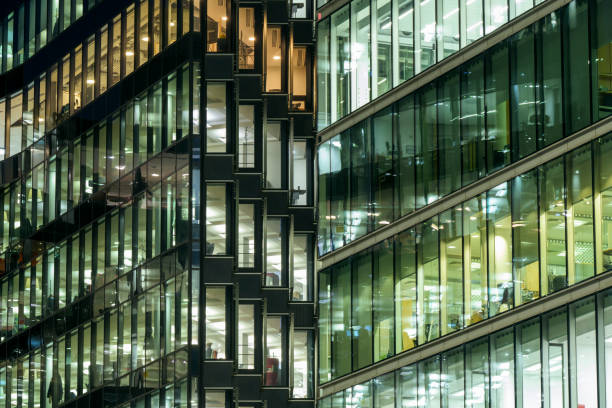 istock Abstract of illuminated modern office windows at night 1354062403