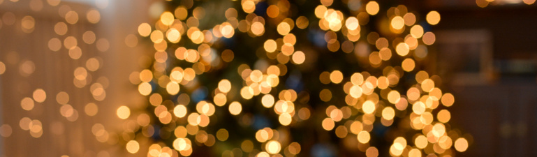 Christmas background. Festive abstract background with bokeh defocused lights.Christmas mood . Happy New Year and Merry Christmas. Banner.Copy space