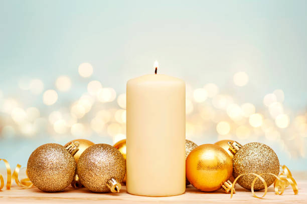 istock Christmas candle and gold ornaments on a blue background 1354062771
