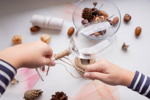 istock Step by step DIY instruction for DIY craft. Autumn composition in glass.A gift from children.set of creativity.Step1. a child winds threads on a glass 1354063463