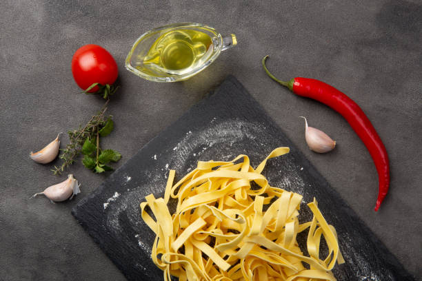 istock Italian pasta cooking process. Fresh food concept. Home made tagliatelle 1354064150