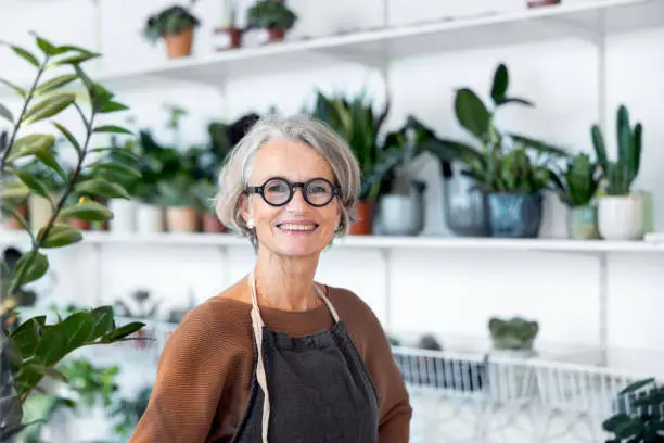 Photo of Portrait of senior female florist in her shop