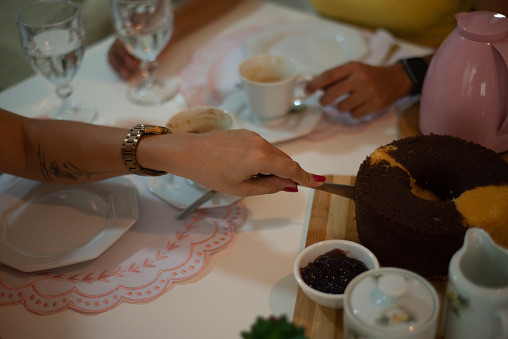 friends together at the cake table. cutting a cake. coffee