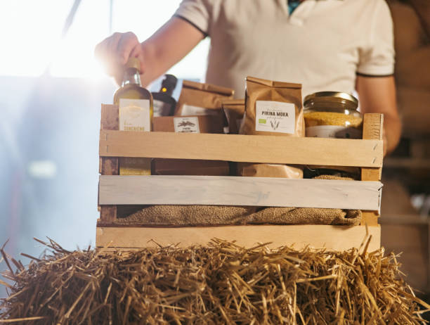 istock Midsection of man picking up oil bottle from crate 1354068158