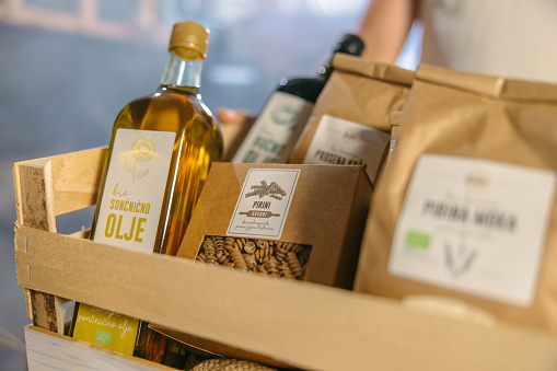 Close up of olive oil bottle and pasta in crate at warehouse