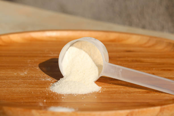 Collagen powder in a measuring spoon on the wooden background Collagen powder in a measuring spoon on the wooden background. Healthy lifestyle human collagen stock pictures, royalty-free photos & images