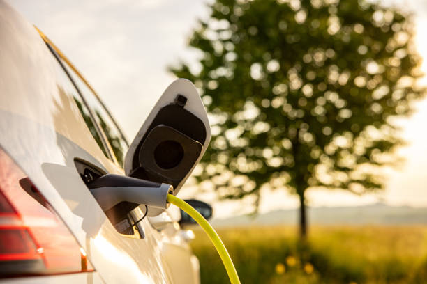 istock Charging an electric car on agriculture field 1354070352