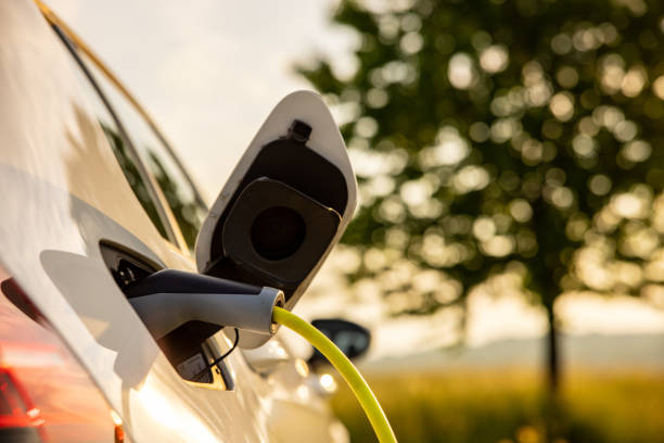 istock Charging an electric car on agriculture field 1354070877