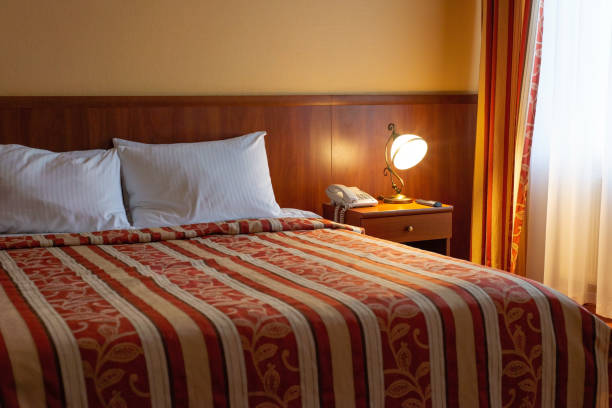 istock hotel bed interior with lamps in warm colors 1354071473