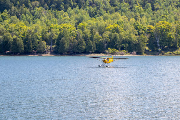 istock yellow seaplane landing on lake 1354071838