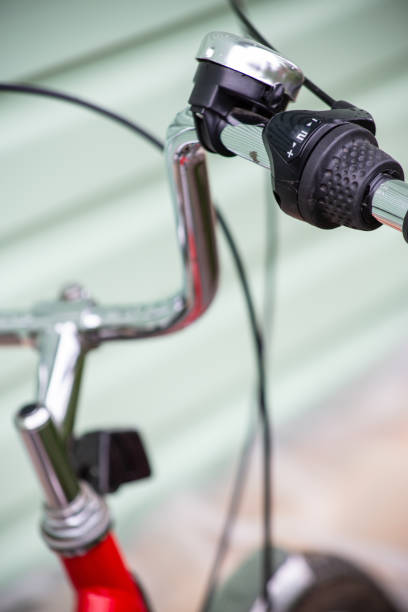 istock Handlebars of a bicycle with a signal and a speed switch attached to it. Close-up. 1354073531