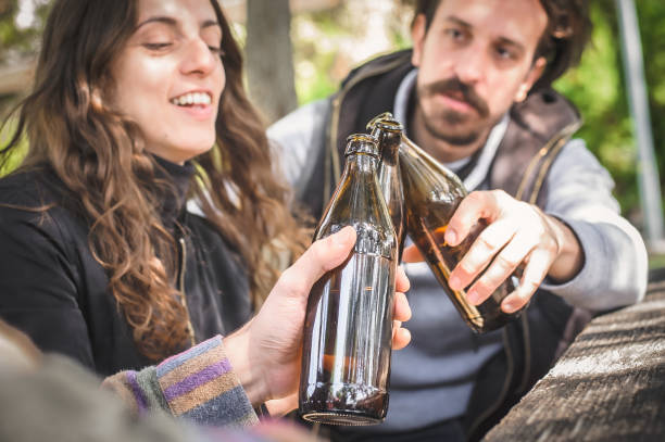 istock Cheers. Smiling cheerful young friends drinks beer from bottle 1354073748