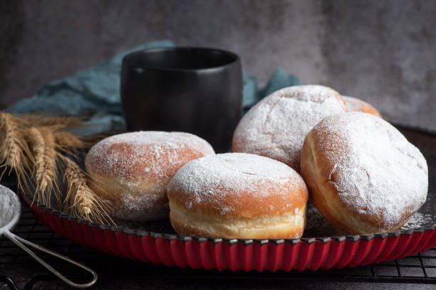 istock Donuts filled with jam sprinkled with powdered sugar and cup of milk 1354074440