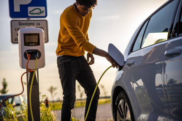 istock African american man inserting plug into the electric car charging socket 1354074599