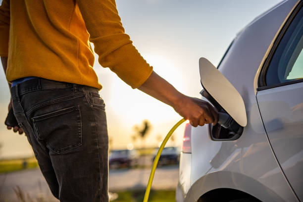 istock African american man inserting plug into the electric car charging socket 1354074602
