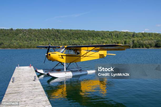 Yellow Seaplane At A Dock Stock Photo - Download Image Now - Private Airplane, Water, Yellow