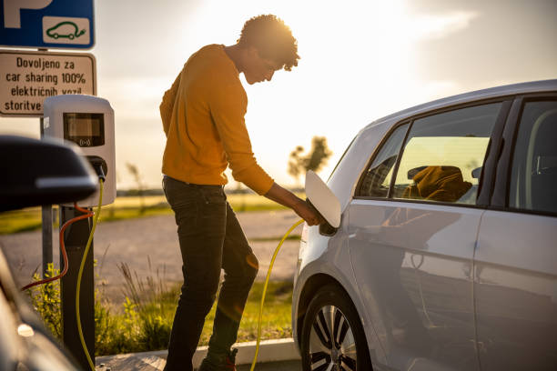 istock African american man inserting plug into the electric car charging socket 1354074700