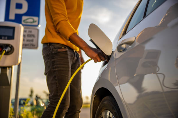 istock African american man inserting plug into the electric car charging socket 1354074717
