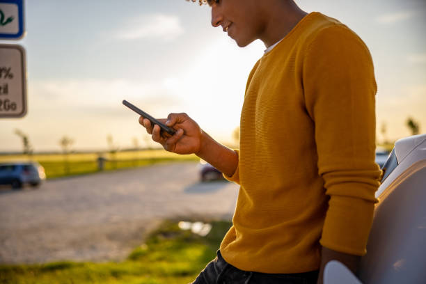 Silhouette of man using mobile phone outdoors