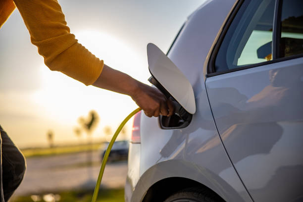 istock African american man inserting plug into the electric car charging socket 1354075023