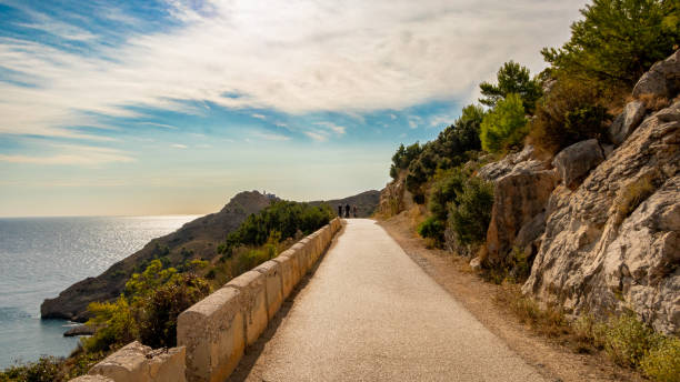 istock Long country road between mountains in the morning 1354075243