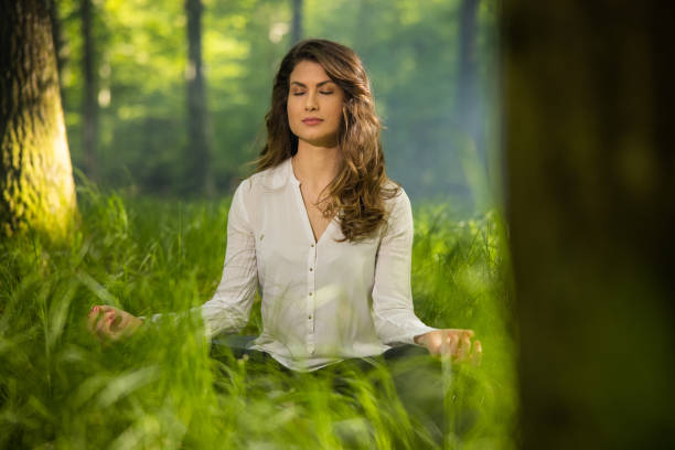 istock Woman practicing yoga in forest 1354076553