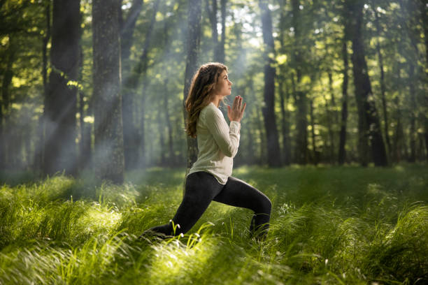 istock Woman practicing yoga in forest 1354077149