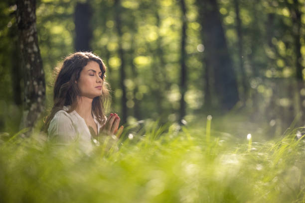istock Young woman doing yoga with joined hands 1354077271