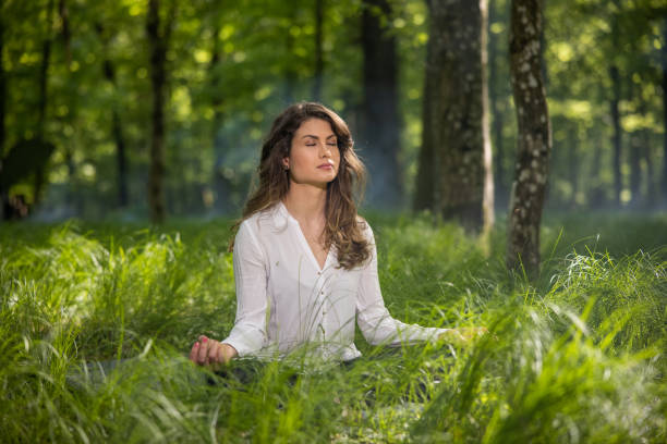 istock Beautiful woman practicing yoga at forest 1354077344