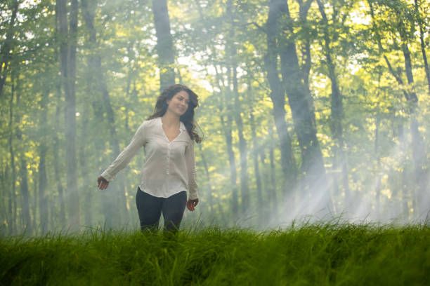 istock Young woman having fun in forest 1354077345