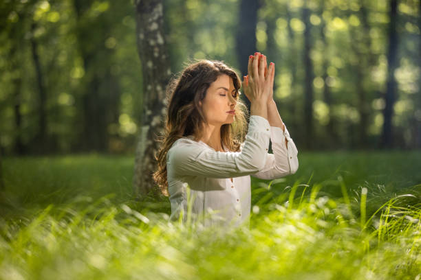 istock Young woman doing yoga with joined hands 1354077420