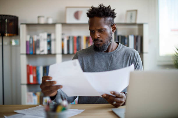 Mid adult man working at home stock photo