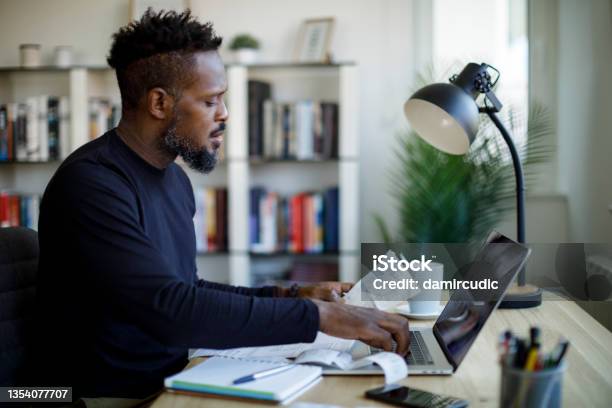 Man Calculating Budget And Finances Stock Photo - Download Image Now - Paycheck, Wages, Tax Form
