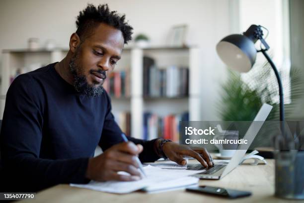Man Working At Home Stock Photo - Download Image Now - Writing - Activity, Men, Examining